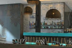 a bar in a restaurant with two chandeliers at Motel One Bremen-Altstadt in Bremen +18 photos