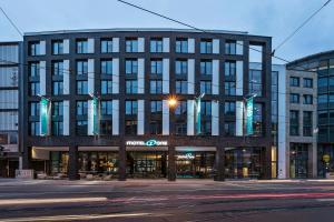 a large building on a city street at night at Motel One Bremen-Altstadt in Bremen
