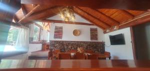 a dining room with a table and chairs and a tv at LADERAS DEL CAMPANARIO in San Carlos de Bariloche