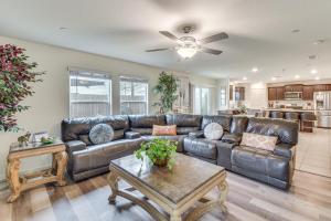 a living room with a leather couch and a table at Pool Table & Patio! Spacious Merced Getaway in Merced