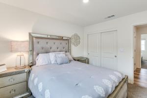 a white bedroom with a large bed and a dresser at Pool Table & Patio! Spacious Merced Getaway in Merced