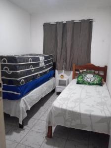 a bedroom with two beds and a window at Casa Estrela do Mar in Conde