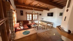 a living room with a couch and a table at Chalúpka pod Rozsutcom in Zázrivá