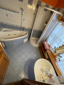 a bathroom with a tub and a toilet and a sink at Chalúpka pod Rozsutcom in Zázrivá +44 photos