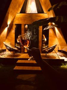 a wine glass sitting on top of a table at A-Frame tiny house in Arusha