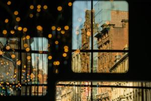 a window with a view of a city with buildings at Motel One Glasgow in Glasgow