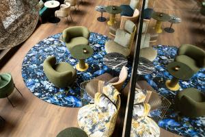 a reflection of a room with chairs and tables at Motel One Brussels in Brussels