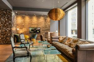 a living room with a couch and chairs at Motel One Brussels in Brussels +31 photos