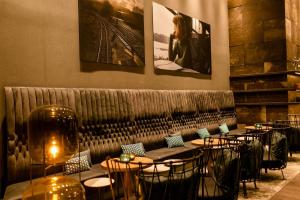 a row of tables and chairs in a restaurant at Motel One Glasgow in Glasgow