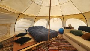 a bedroom with a bed in a tent at Olas de Chile Ecocamp in Pichilemu