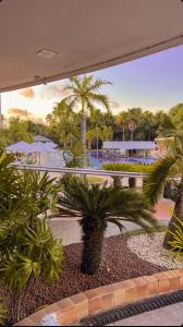 a view of a resort with palm trees at Gran Lençóes Flat Residence in Barreirinhas