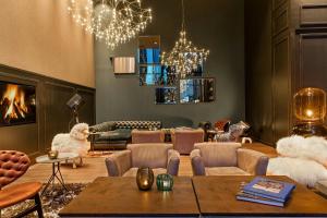 a living room with furniture and a fireplace at Motel One Glasgow in Glasgow