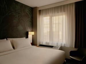 a bedroom with a white bed and a window at The Cloud One New York-Downtown, by the Motel One Group in New York