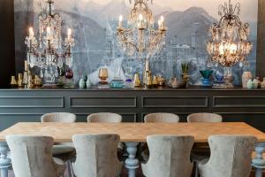 a dining room with a table and chandeliers at Motel One München-Sendlinger Tor in Munich