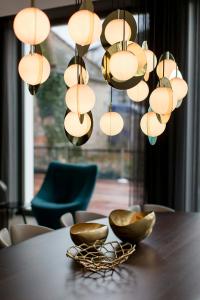 a table with a bunch of lights hanging over it at Motel One München-Olympia Gate in Munich