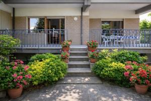 a porch with potted plants and stairs to a house at Sorrento Life 1 in Sant'Agnello