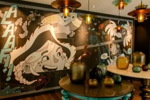 a wall with a painting of a woman and pumpkins at Motel One Köln-Mediapark in Cologne
