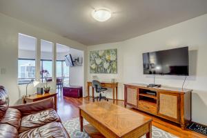 a living room with a couch and a flat screen tv at Free Parking Pool Harbor View Access Honolulu Gem! in Honolulu