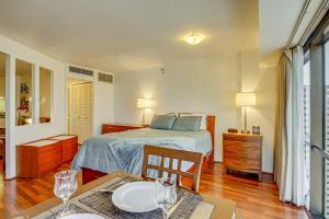 a bedroom with a bed and a table with a dining room at Free Parking Pool Harbor View Access Honolulu Gem! in Honolulu +17 photos