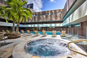 a pool with chairs and a palm tree on a building at Free Parking Pool Harbor View Access Honolulu Gem! in Honolulu