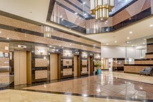 a lobby of a hotel with doors and a chandelier at Free Parking Pool Harbor View Access Honolulu Gem! in Honolulu