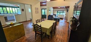 a dining room with a table and chairs in a room at Pousada dos Anjos in Cunha