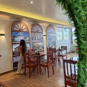 a woman standing at a table in a restaurant at Hotel Yagua Iquitos in Iquitos +21 photos