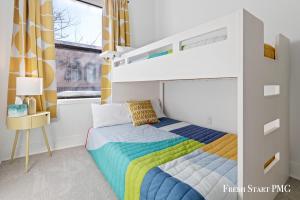 a bedroom with a bunk bed with a rainbow at City View Loft in Saint Joseph