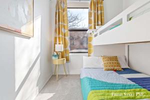 a bedroom with a bed with a colorful blanket at City View Loft in Saint Joseph
