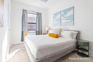a white bedroom with a bed and a window at City View Loft in Saint Joseph +72 photos