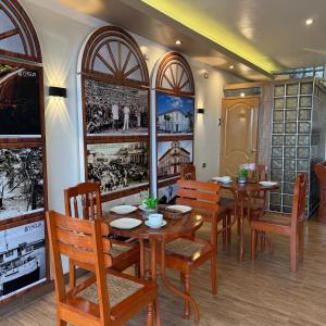 a dining room with wooden tables and chairs at Hotel Yagua Iquitos in Iquitos