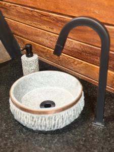 a bathroom sink with a faucet next to a counter at Black Hut in Domingos Martins