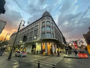 a large building on a city street at dusk at Hotel Zamora Downtown CDMX in Mexico City