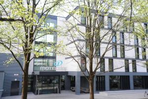 two trees in front of a building at Motel One München-Deutsches Museum in Munich