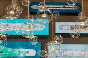 a bunch of glass bubbles hanging from a ceiling at Motel One Köln-Altstadt in Cologne +33 photos