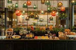 a buffet with food on a table with lights at Motel One Köln-Neumarkt in Cologne