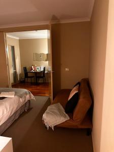 a living room with a couch and a table at Exclusive B and B room in Lyndhurst