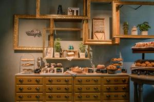 a bakery with a dresser with bread and pastries on it at Motel One Hannover-Oper in Hannover