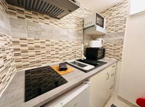 a kitchen with a stove and a counter top at La Bastide in Carcassonne +4 photos