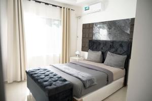a bedroom with a large bed with a large window at 2nd street ibex Apartment in Lusaka