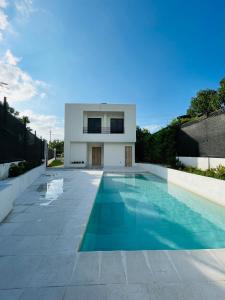 a swimming pool in front of a house at Villa Sierra Mar in Playa Bello Horizonte