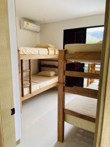 a room with three bunk beds with a television at Villa Sierra Mar in Playa Bello Horizonte +29 photos