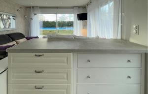 a kitchen with a large counter with white drawers at Studio Tout Confort in Fondettes