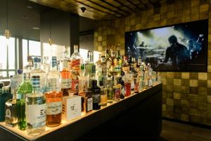 a bar with a lot of bottles of alcohol at Motel One Mannheim in Mannheim