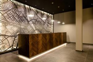 a lobby with a wall with a painting on it at Motel One Mannheim in Mannheim