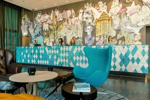 a room with a large mural on the wall at Motel One München-Messe in Munich