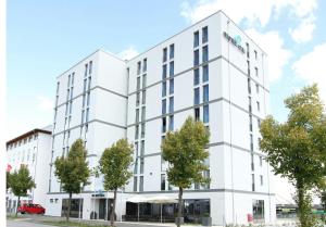 an image of a white building at Motel One München-Garching in Garching bei München