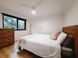 a bedroom with a large bed and a window at Moonlight Ridge Chalet in Merrijig
