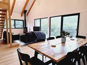 a living room with a wooden table and chairs at Moonlight Ridge Chalet in Merrijig