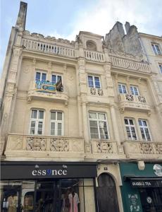 a large building with a store in front of it at La Cime - Duplex hypercentre, Wi-Fi & restaurant in Caen